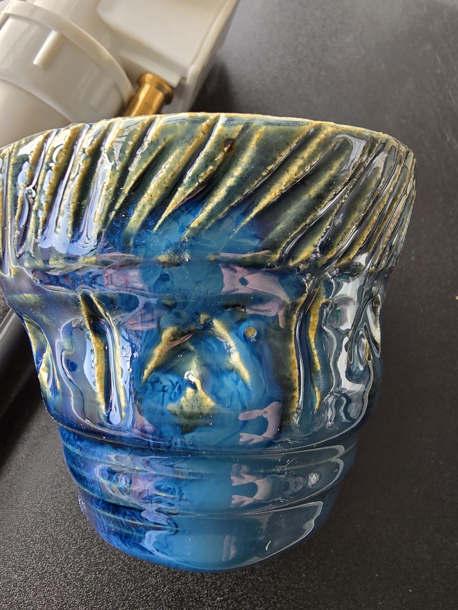 Blue textured glazed ceramic pot with wave pattern