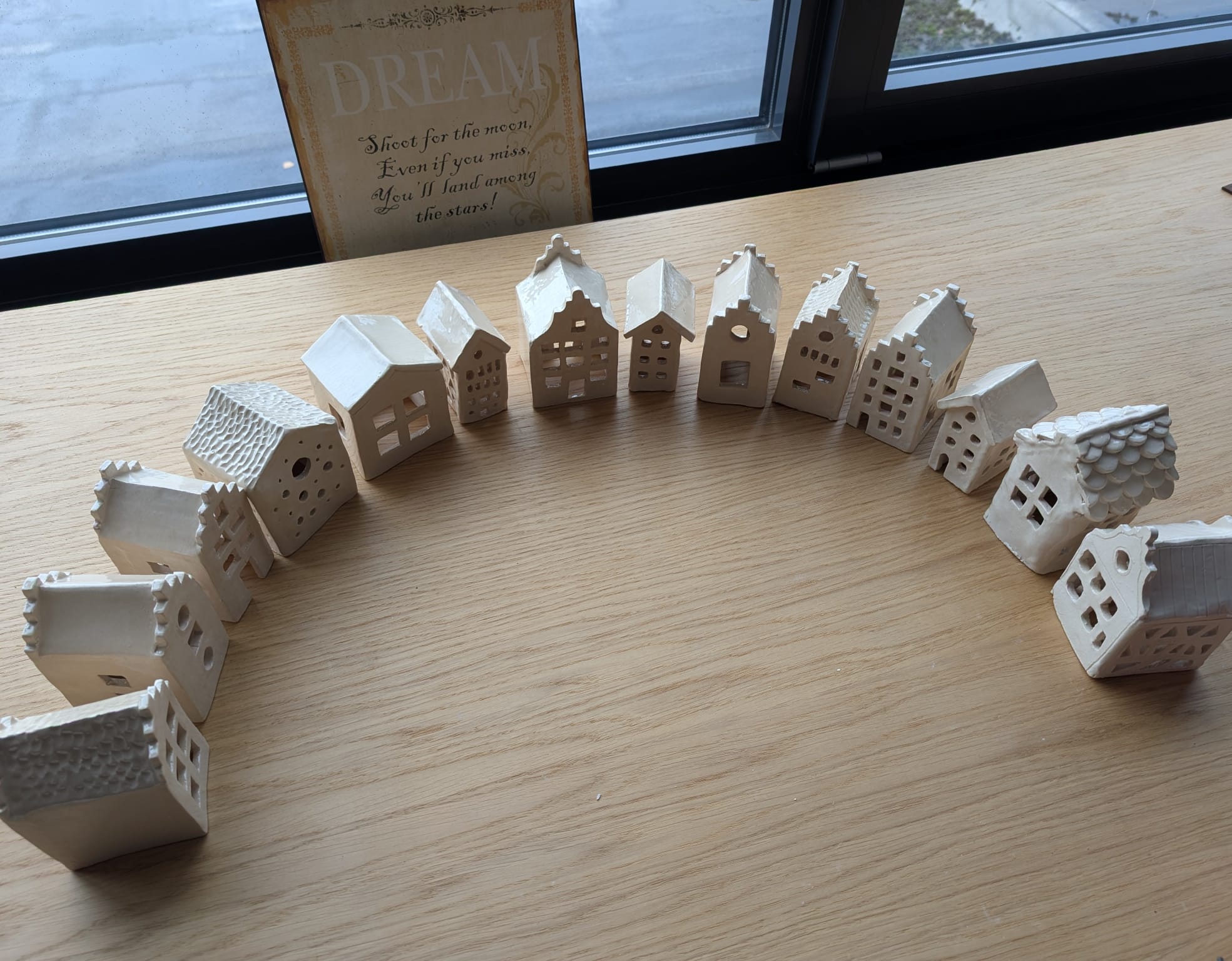 Miniature ceramic houses arranged in a semicircle