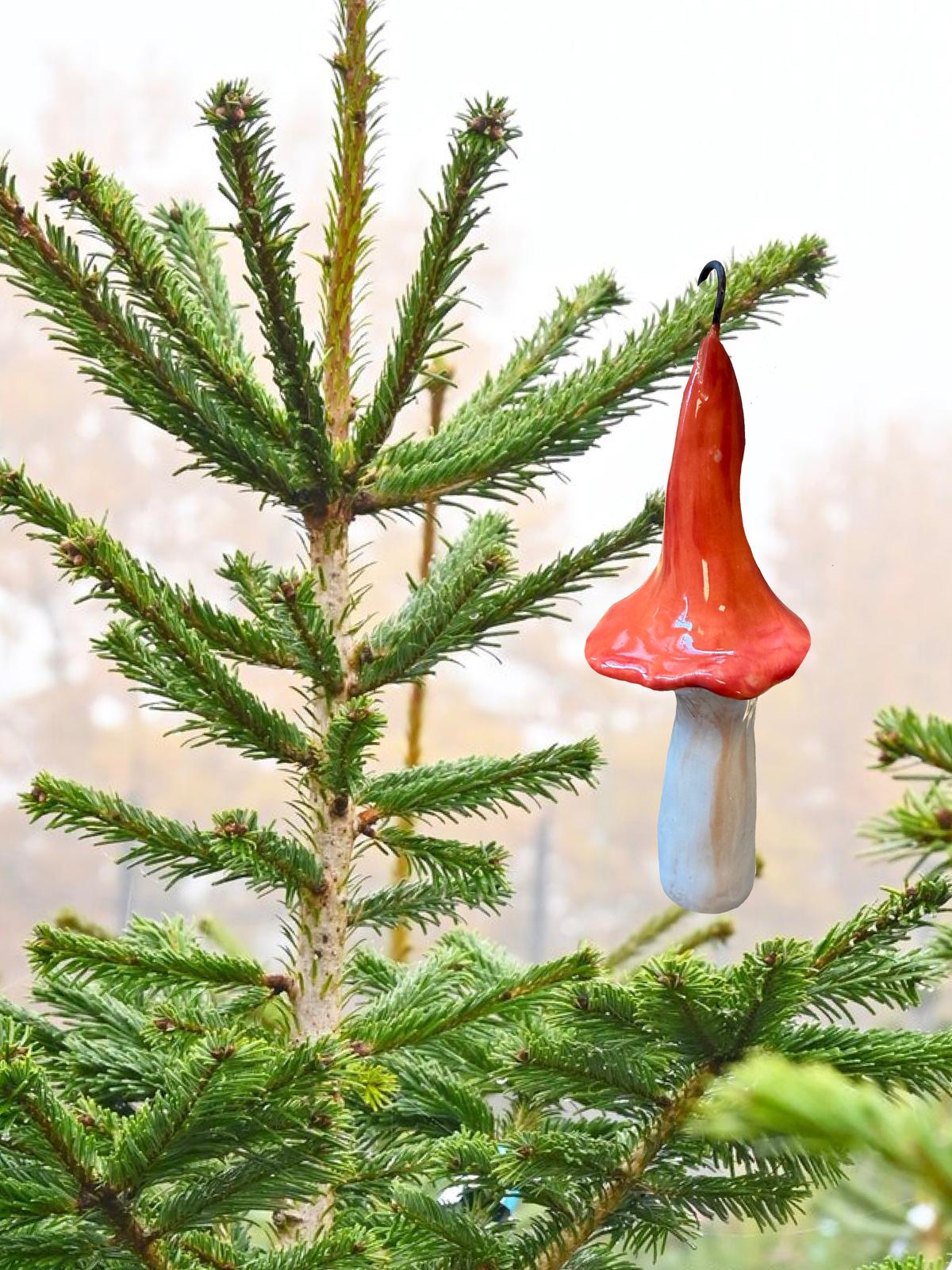 Glazed ceramic mushroom ornament hanging on a tree